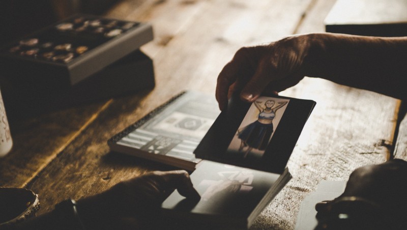 Someone pulling a card with a dancer on it.