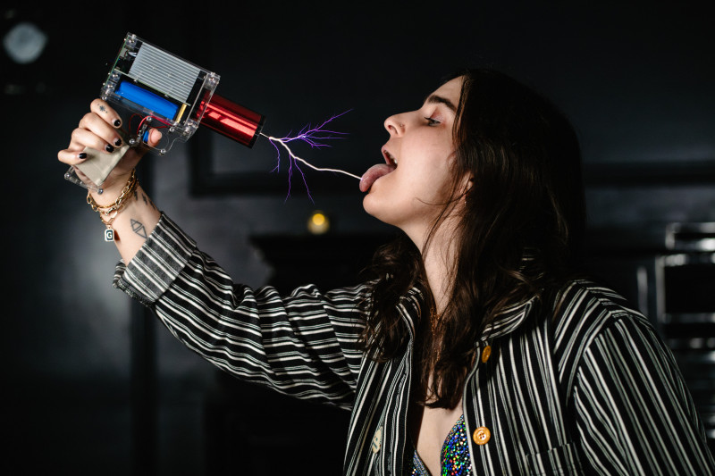 Electro Girly applying electric shocks to her own tongue.